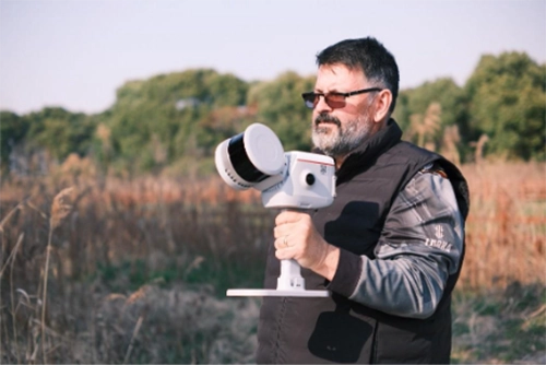 Man holding ComNav LS600 Laser Scanner
