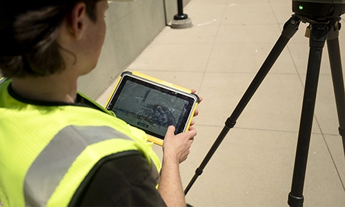 Trimble T100 tablet with lady surveyor