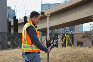 Field Engineer land survey with Trimble TSC710 under an overpass